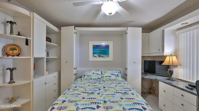 4139 S Atlantic Ave Unit A406, New Smyrna Beach, FL 32169 - bedroom with a textured ceiling, a ceiling fan, and built in desk