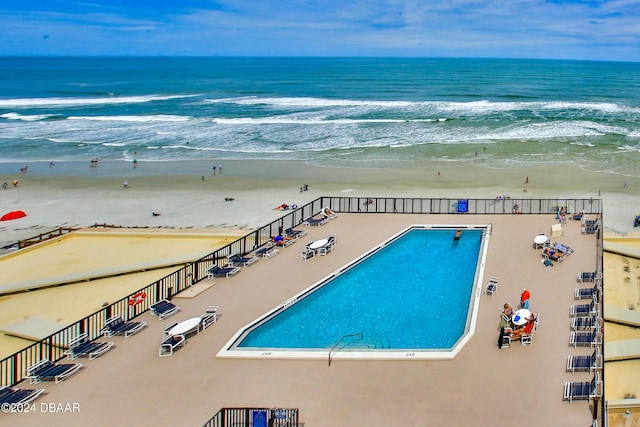 4139 S Atlantic Ave Unit A406, New Smyrna Beach, FL 32169 - bird's eye view of waterfront with a beach and a pool area