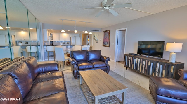 4139 S Atlantic Ave Unit A406, New Smyrna Beach, FL 32169 - living area with ceiling fan, track lighting, a textured ceiling, and light tile patterned floors