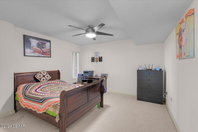 bedroom featuring ceiling fan and light carpet