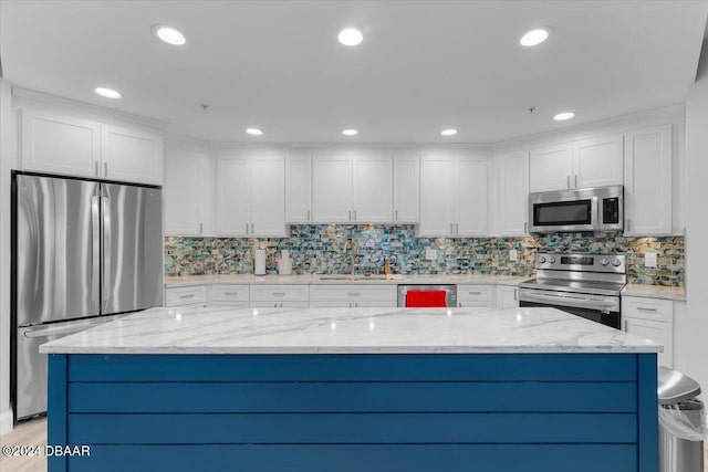 kitchen featuring white cabinetry, light stone counters, and appliances with stainless steel finishes