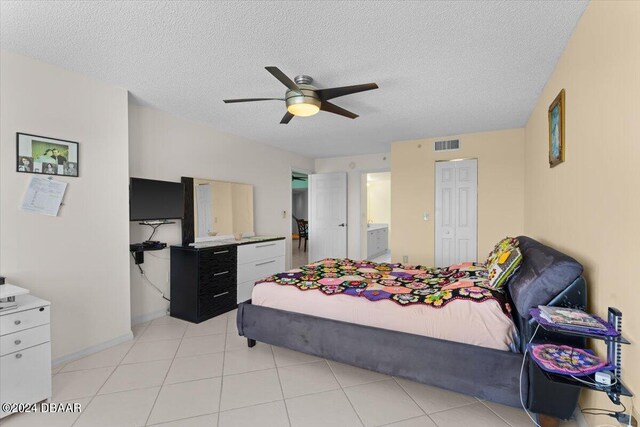 bedroom with a textured ceiling, ceiling fan, and a closet