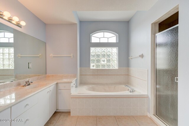 12 Sea Swallow Ter, Ormond Beach, FL 32176 - bathroom with vanity, a bath, tile patterned floors, and a shower stall