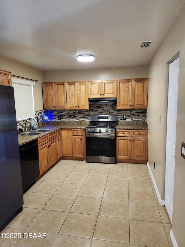 812 S Kottle Cir Unit S, Daytona Beach, FL 32114 - kitchen featuring gas range, freestanding refrigerator, black dishwasher, a sink, and under cabinet range hood