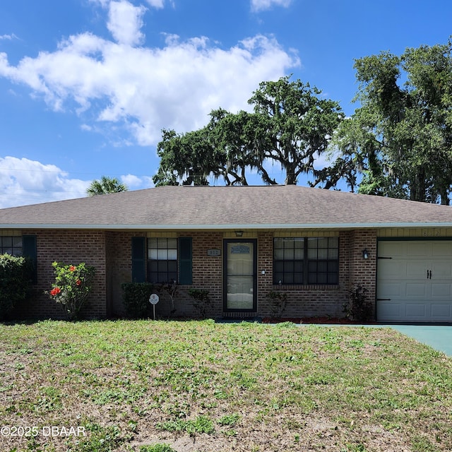 812 S Kottle Cir Unit S, Daytona Beach, FL 32114 - ranch-style house featuring an attached garage, brick siding, a front lawn, driveway, and a shingled roof