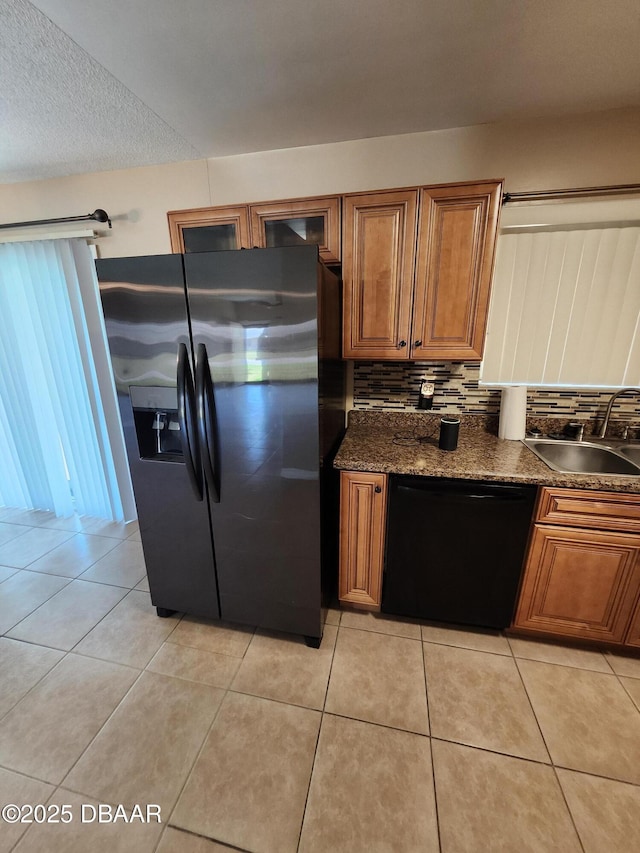 812 S Kottle Cir Unit S, Daytona Beach, FL 32114 - kitchen with black appliances, a sink, brown cabinets, and light tile patterned flooring