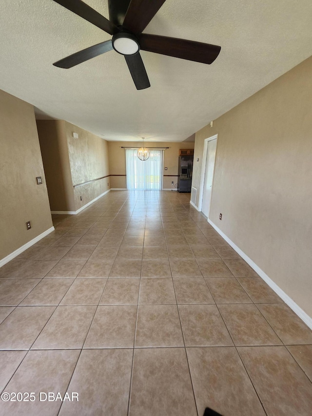 812 S Kottle Cir Unit S, Daytona Beach, FL 32114 - unfurnished room with a chandelier, a textured ceiling, ceiling fan, light tile patterned floors, and baseboards
