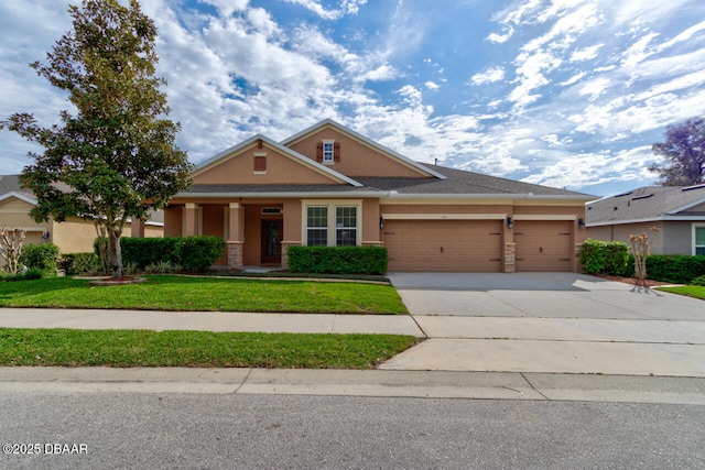 view of front facade with a garage, a front lawn, concrete driveway, and stucco siding