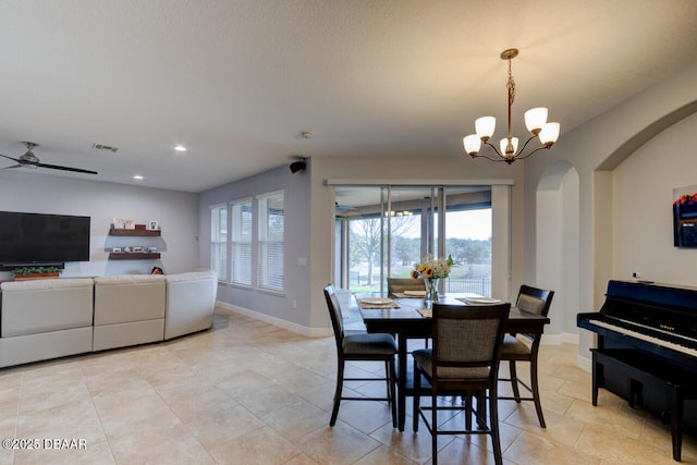 dining room with arched walkways, recessed lighting, ceiling fan with notable chandelier, visible vents, and baseboards