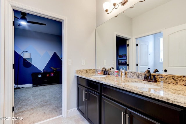 full bathroom featuring double vanity, baseboards, and a sink