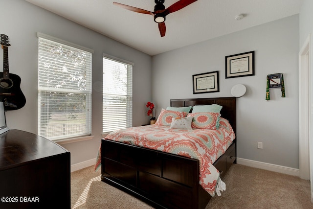 bedroom featuring light carpet, a ceiling fan, and baseboards