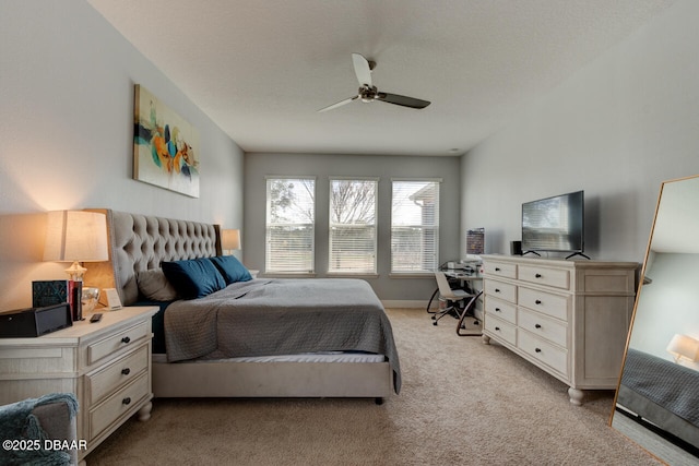 bedroom with light carpet, ceiling fan, and a textured ceiling