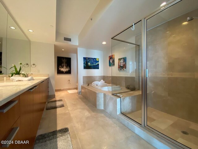 bathroom with vanity and separate shower and tub