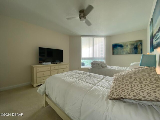 bedroom featuring ceiling fan and light colored carpet