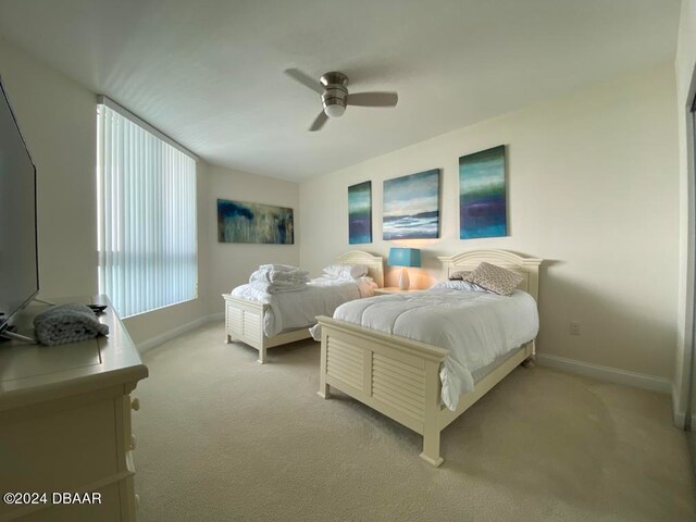 bedroom featuring light carpet and ceiling fan