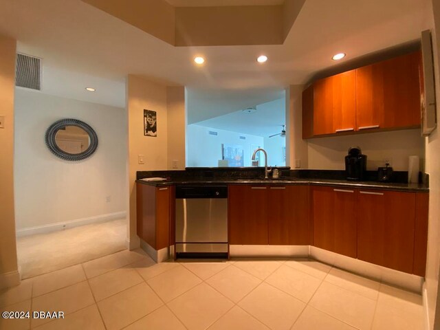 kitchen with stainless steel dishwasher, light tile patterned flooring, and sink