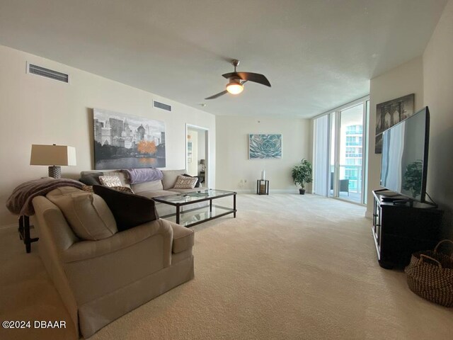 carpeted living room featuring ceiling fan