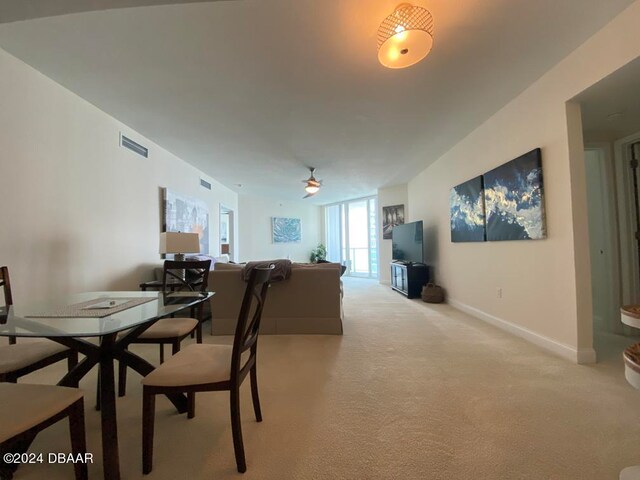 dining area featuring light carpet