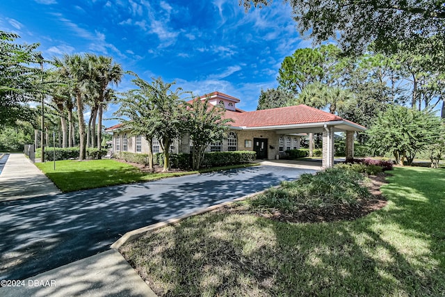 mediterranean / spanish-style house featuring a front lawn