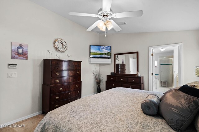 carpeted bedroom with ceiling fan, connected bathroom, and vaulted ceiling