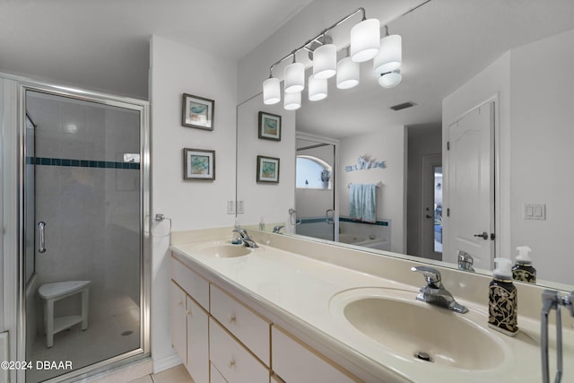 bathroom featuring tile patterned flooring, vanity, and a shower with door