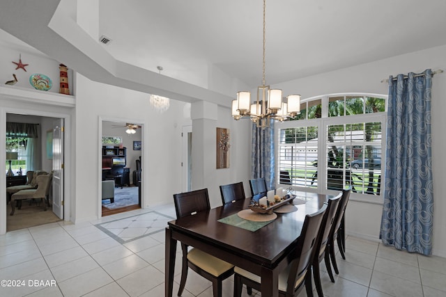 dining room featuring light tile patterned flooring and ceiling fan with notable chandelier