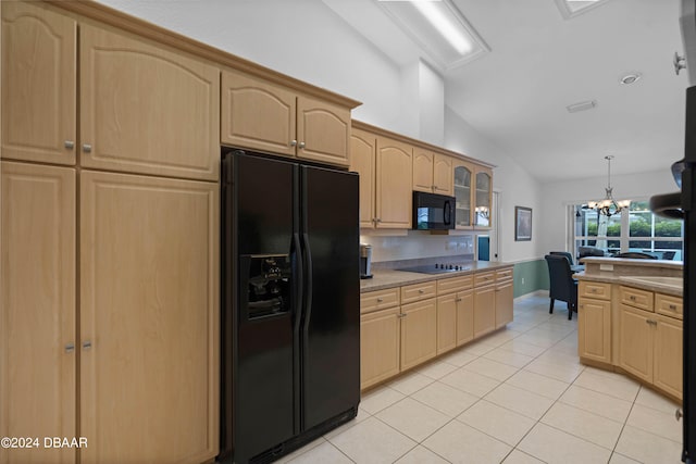 kitchen with black appliances, light tile patterned floors, a chandelier, pendant lighting, and vaulted ceiling