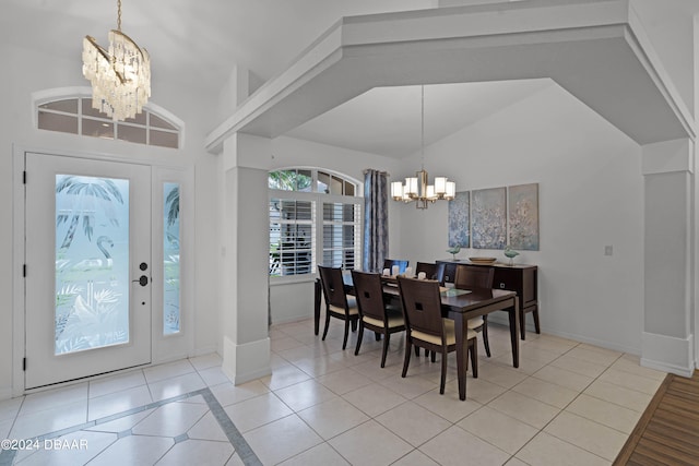 tiled dining area featuring vaulted ceiling and a notable chandelier