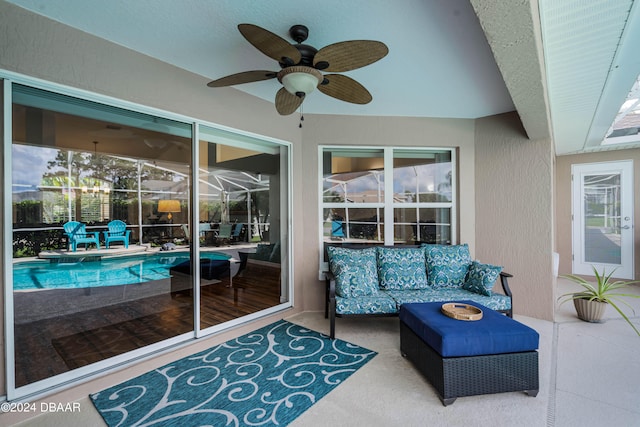 view of patio / terrace with a fenced in pool, an outdoor hangout area, a lanai, and ceiling fan