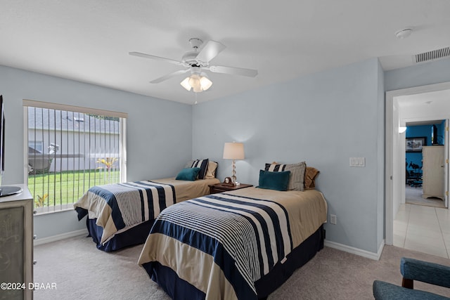 bedroom featuring light carpet and ceiling fan