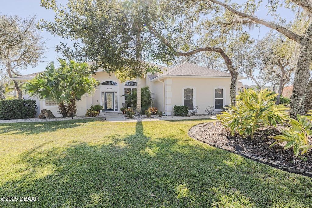 mediterranean / spanish house with a front yard