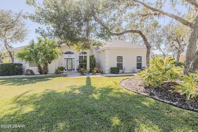 mediterranean / spanish house with a front yard