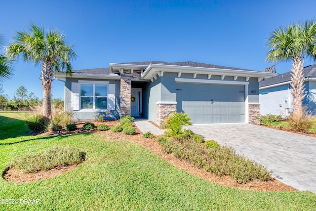 view of front of house featuring a front yard and a garage