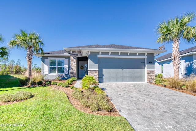 view of front of home with a front yard and a garage