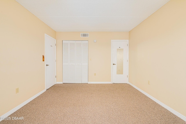 unfurnished room with carpet and baseboards