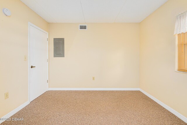 empty room with carpet floors, electric panel, a smoke detector, and baseboards