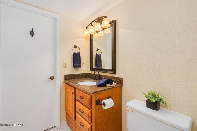 bathroom featuring toilet and vanity