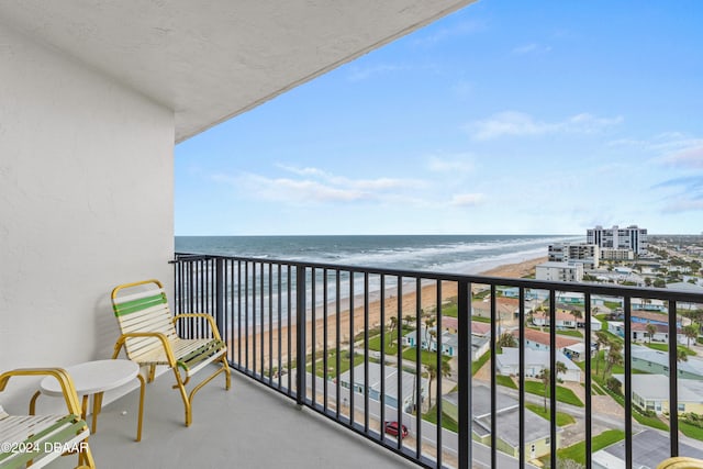 balcony featuring a beach view and a water view