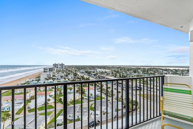 balcony featuring a water view and a beach view