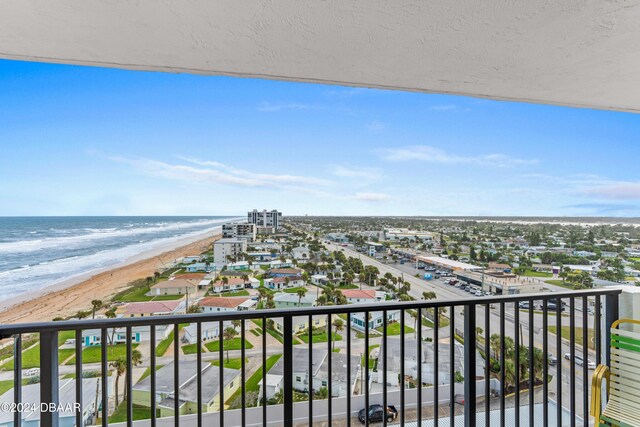 birds eye view of property featuring a beach view and a water view