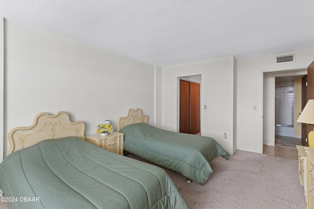 carpeted bedroom with a textured ceiling