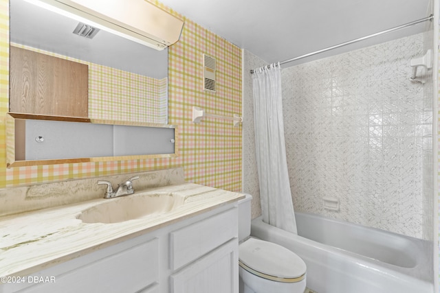 full bathroom with vanity, shower / bath combination with curtain, and toilet