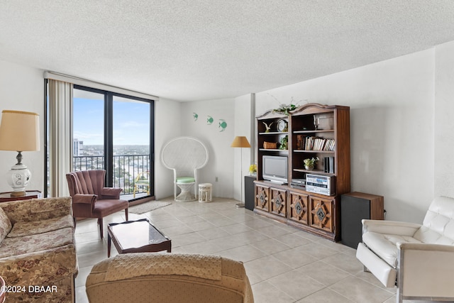 tiled living room with a textured ceiling and a wall of windows