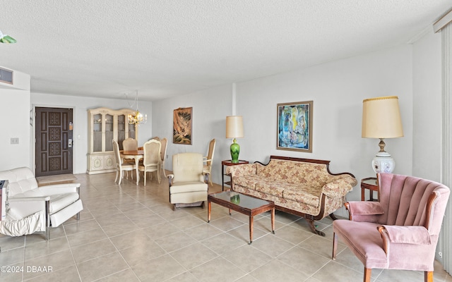 living room with a textured ceiling, a chandelier, and light tile patterned flooring