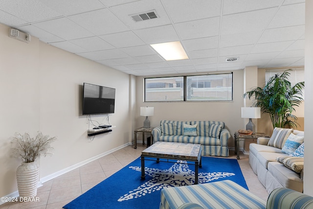 tiled living room featuring a drop ceiling