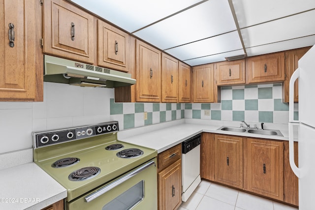 kitchen featuring backsplash, white appliances, sink, and light tile patterned floors