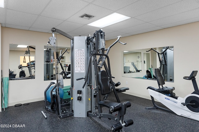 exercise room with a paneled ceiling