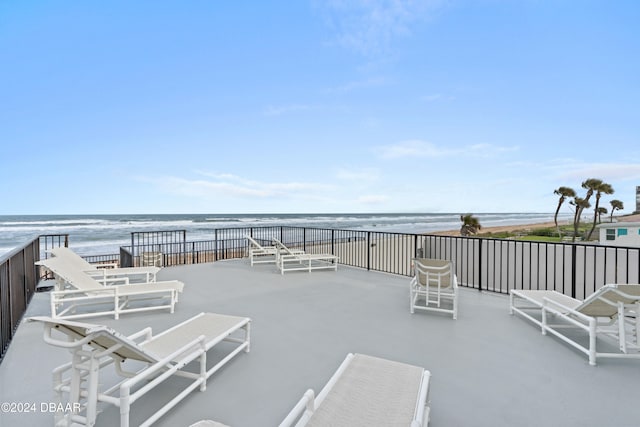 view of patio with a view of the beach and a water view