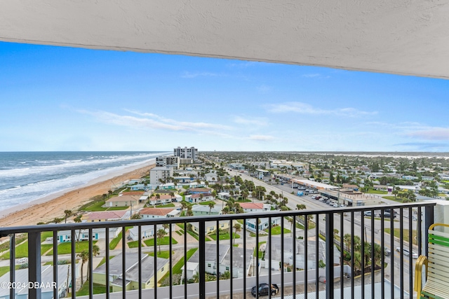 balcony with a water view and a beach view