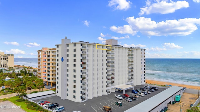 view of property with a beach view and a water view